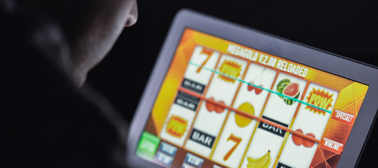 Eine Person spielt auf einem Tablet ein Glücksspiel