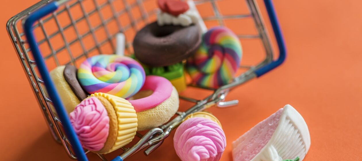 Bunte Süßigkeiten liegen in einem Einkaufskorb
